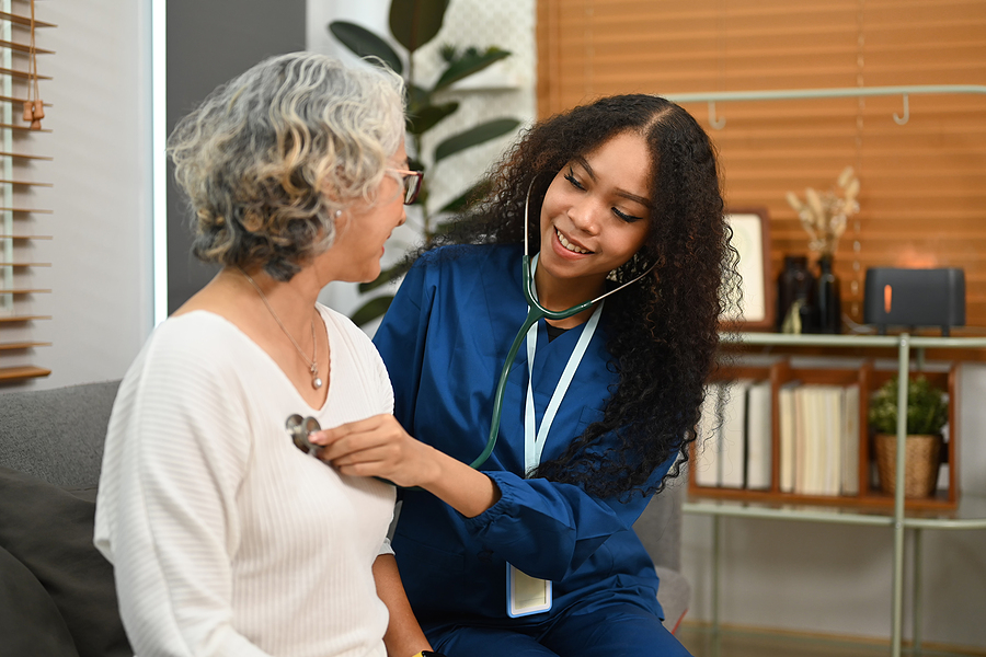 Medical assistant caring for a patient in a doctor's office.