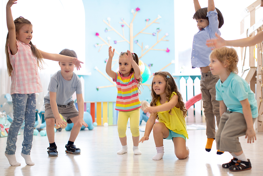 Young preschool students playing in a classroom.