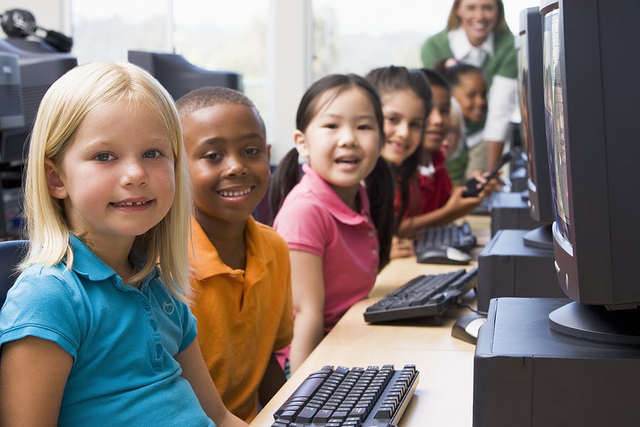 Preschool students learning in a computer lab at school.