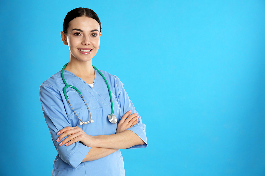 Young medical assistant wearing scrubs and a stethoscope. 