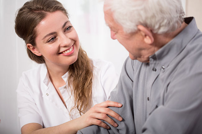 bigstock-Smiling-Nurse-Assisting-Senior-84769652.jpg