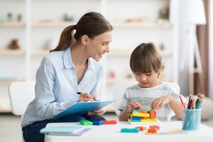 Early childhood educator working with a young student. 