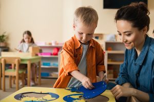Preschool teacher working on a learning activity with her student. 