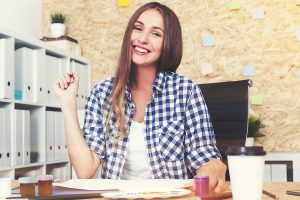 Woman sitting at her desk smiling